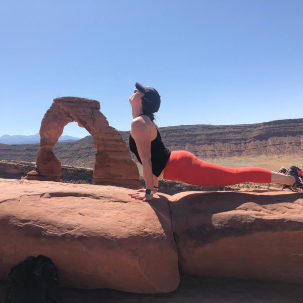 Isabel doing yoga in Arches Moab