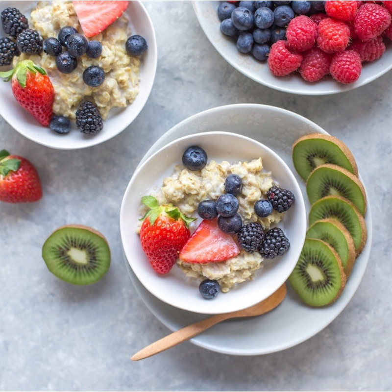 Kiwi around a bowl of yogurt and fruits